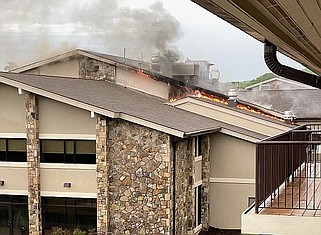 Hamilton County Office of Emergency Management / Flames nip the eaves of Alexian Village's dining hall and kitchen on Signal Mountain on Monday.